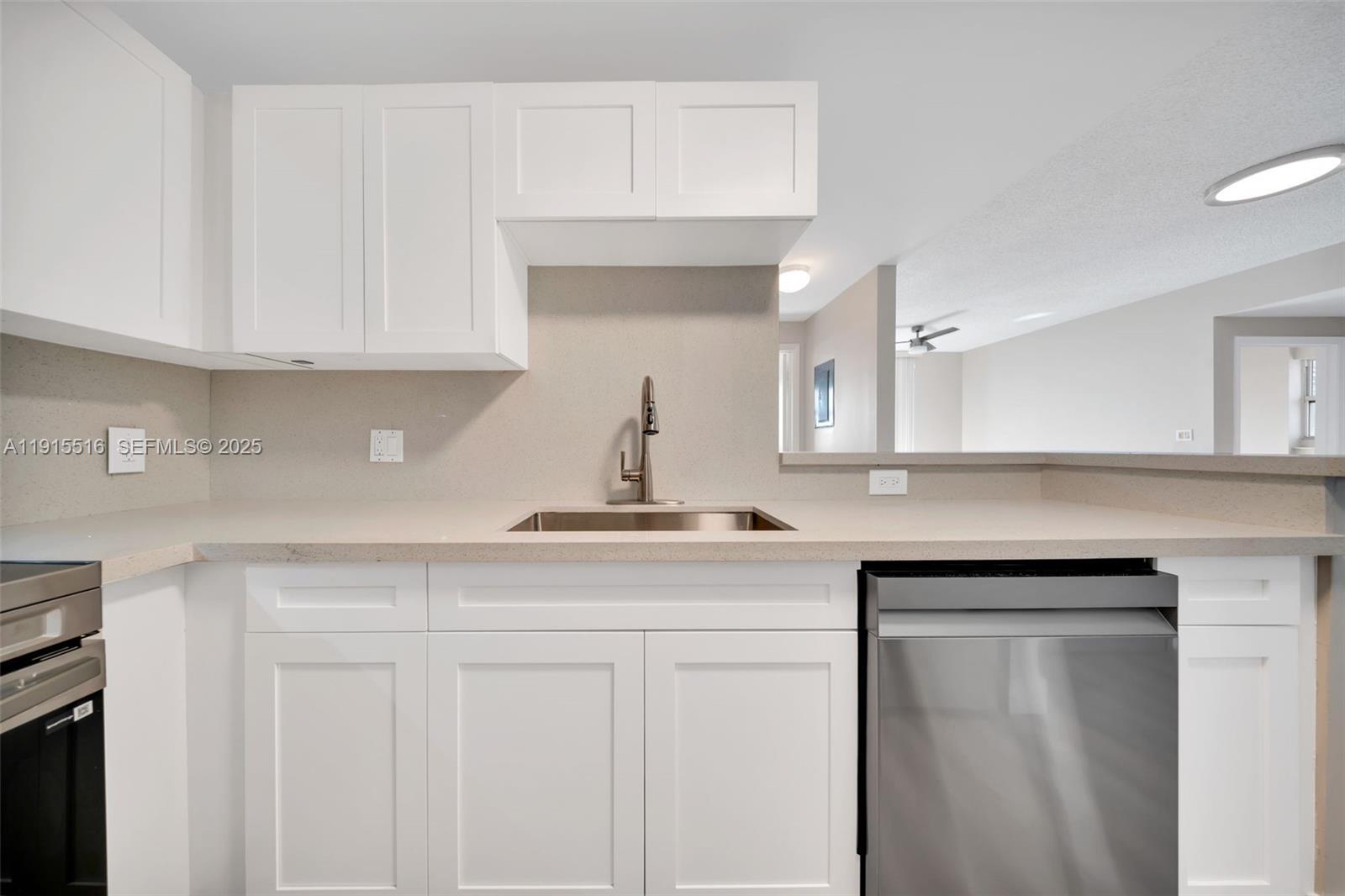 185 Southeast 14th Terrace, Unit 2008 Miami, FL 33131 - Photo 3 of 26 a kitchen with white cabinets and sink