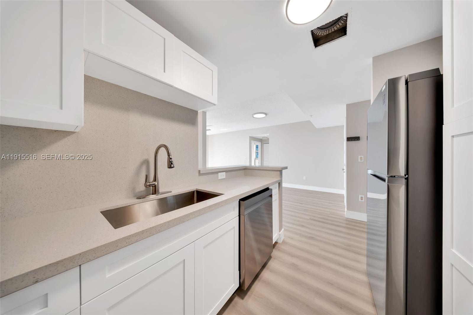 185 Southeast 14th Terrace, Unit 2008 Miami, FL 33131 - Photo 4 of 26 a kitchen with refrigerator and cabinets