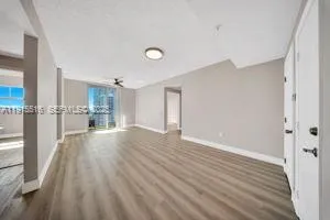 a view of empty room with wooden floor