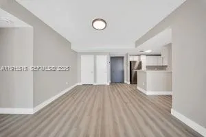 a view of a kitchen with a sink and a refrigerator