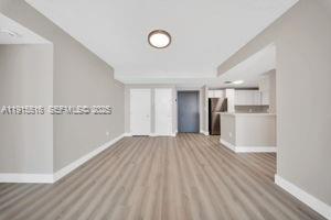 185 Southeast 14th Terrace, Unit 2008 Miami, FL 33131 - Photo 6 of 26 a view of a kitchen with a sink and a refrigerator