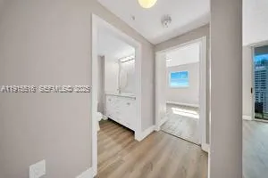 a view of a hallway with wooden floor