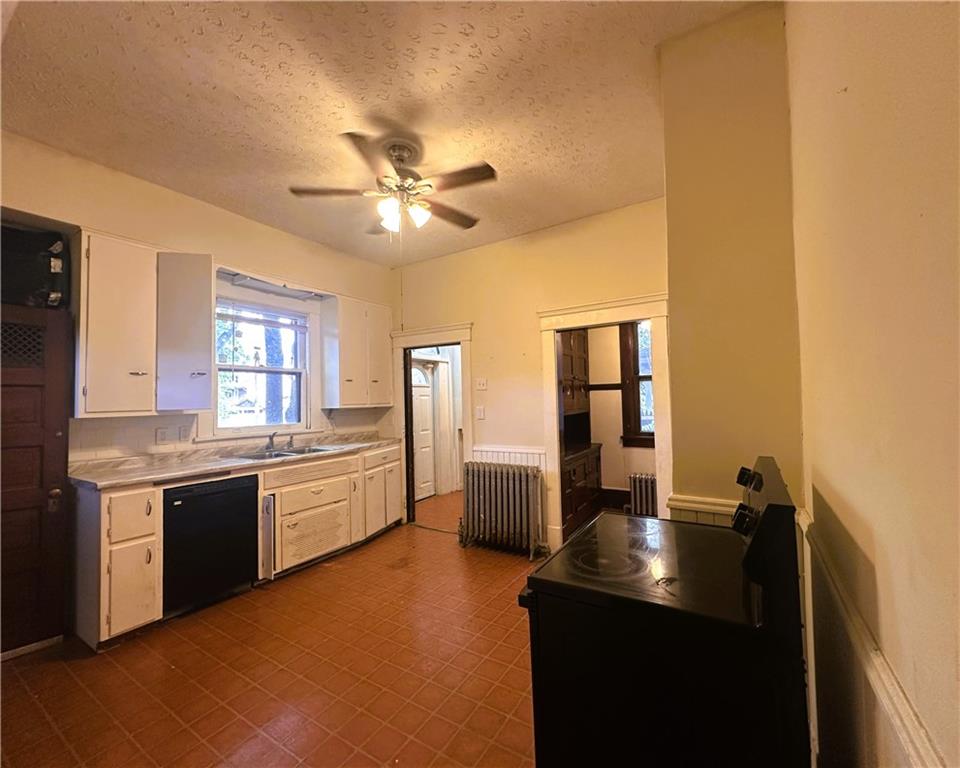 150 Euclid Avenue Sharon, PA 16146 - Photo 17 of 49 a kitchen with a sink dishwasher a stove and a refrigerator with wooden floor