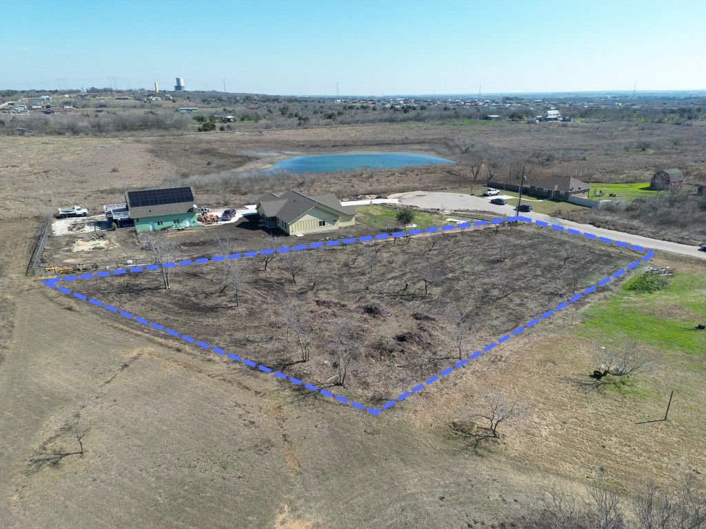 433 East Ridge Lane Kyle, TX 78640 - Photo 2 of 3 Aerial view of property's location featuring property parcel outlined, a large body of water, and rural landscape