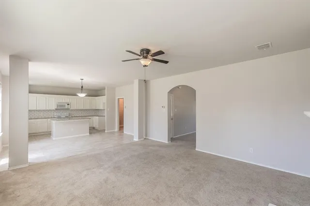 a view of a kitchen with a sink and a refrigerator