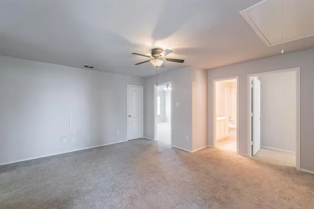 a view of an empty room with a ceiling fan