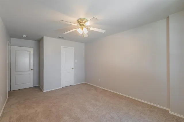 a view of an empty room with a fan