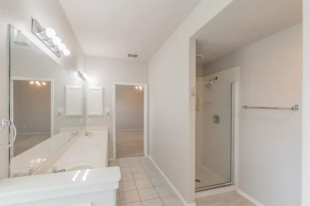 a bathroom with a glass shower door