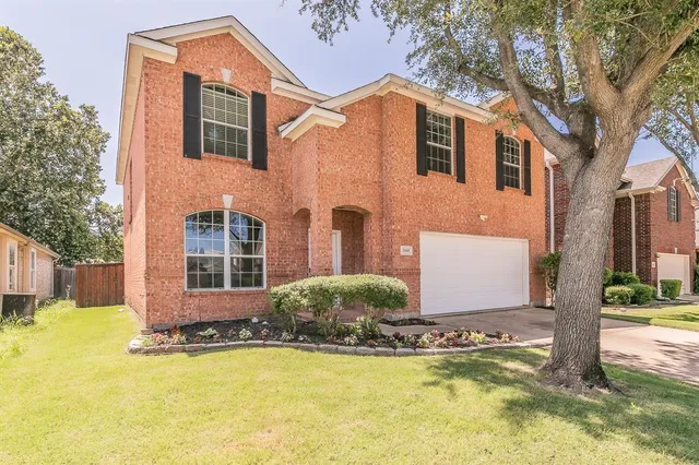 a front view of house with yard and trees around