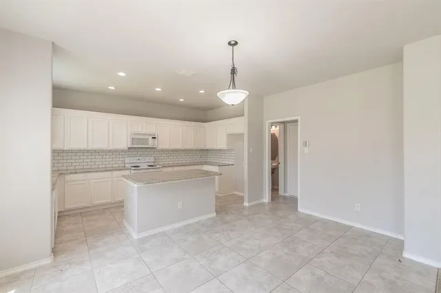 a view of a kitchen with a sink and dishwasher a refrigerator
