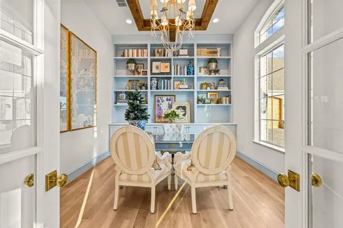 a view of a dining room with furniture and a book shelf