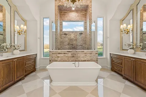 a spacious bathroom with a tub sink and mirror