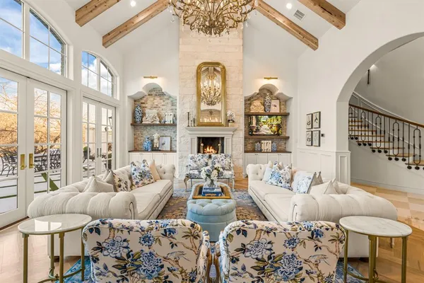 a living room with furniture fireplace and a large window