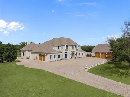 a front view of a house with a garden and yard