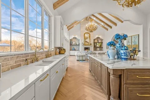 a large white kitchen with a large window
