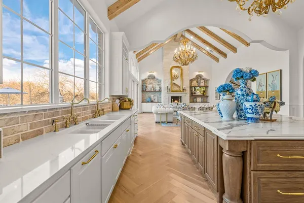 a kitchen with stainless steel appliances granite countertop a lot of cabinets and wooden floor