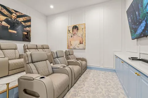 a living room with furniture and wall painting