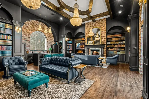 a living room with fireplace furniture and a book shelf