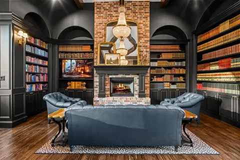 a living room with fireplace furniture and a book shelf