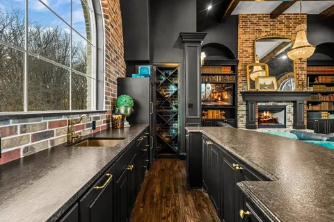 a kitchen with stainless steel appliances granite countertop sink stove and cabinets