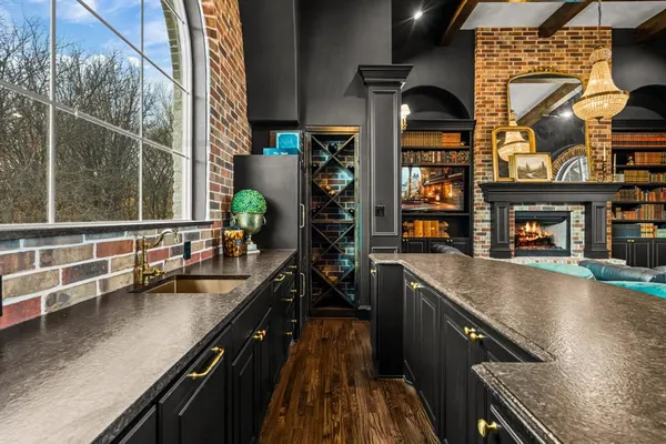 a living room with furniture a fireplace and a floor to ceiling window