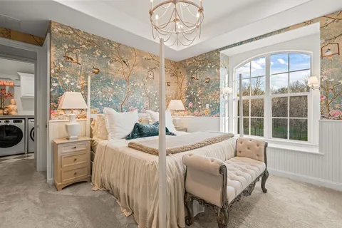 a bedroom with furniture and large windows