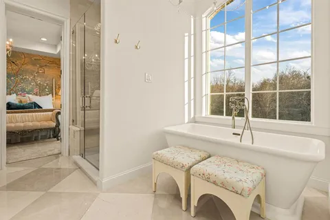 a living room with furniture and a floor to ceiling window