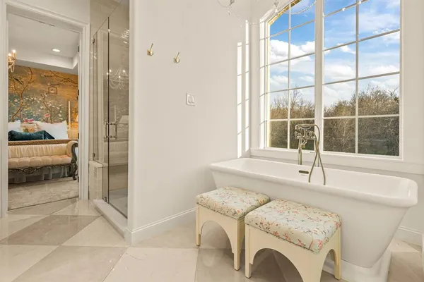 a spacious bedroom with a bed and a window