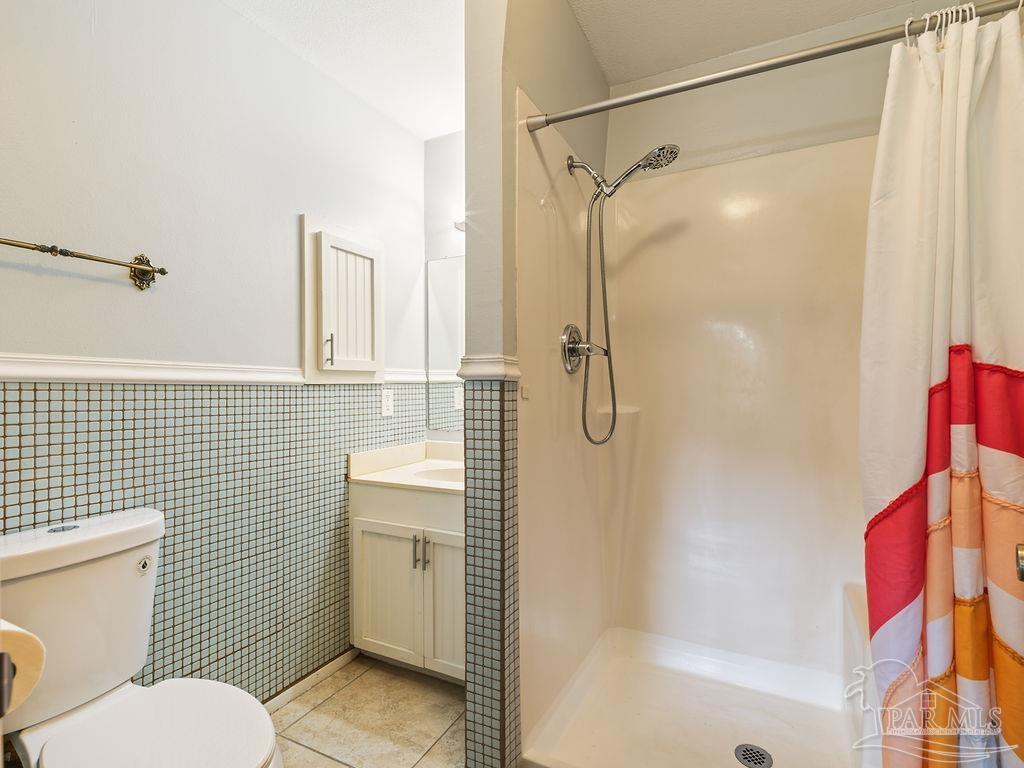 609 Dog Track Road Pensacola, FL 32506 - Photo 20 of 22 a bathroom with a shower a toilet and sink