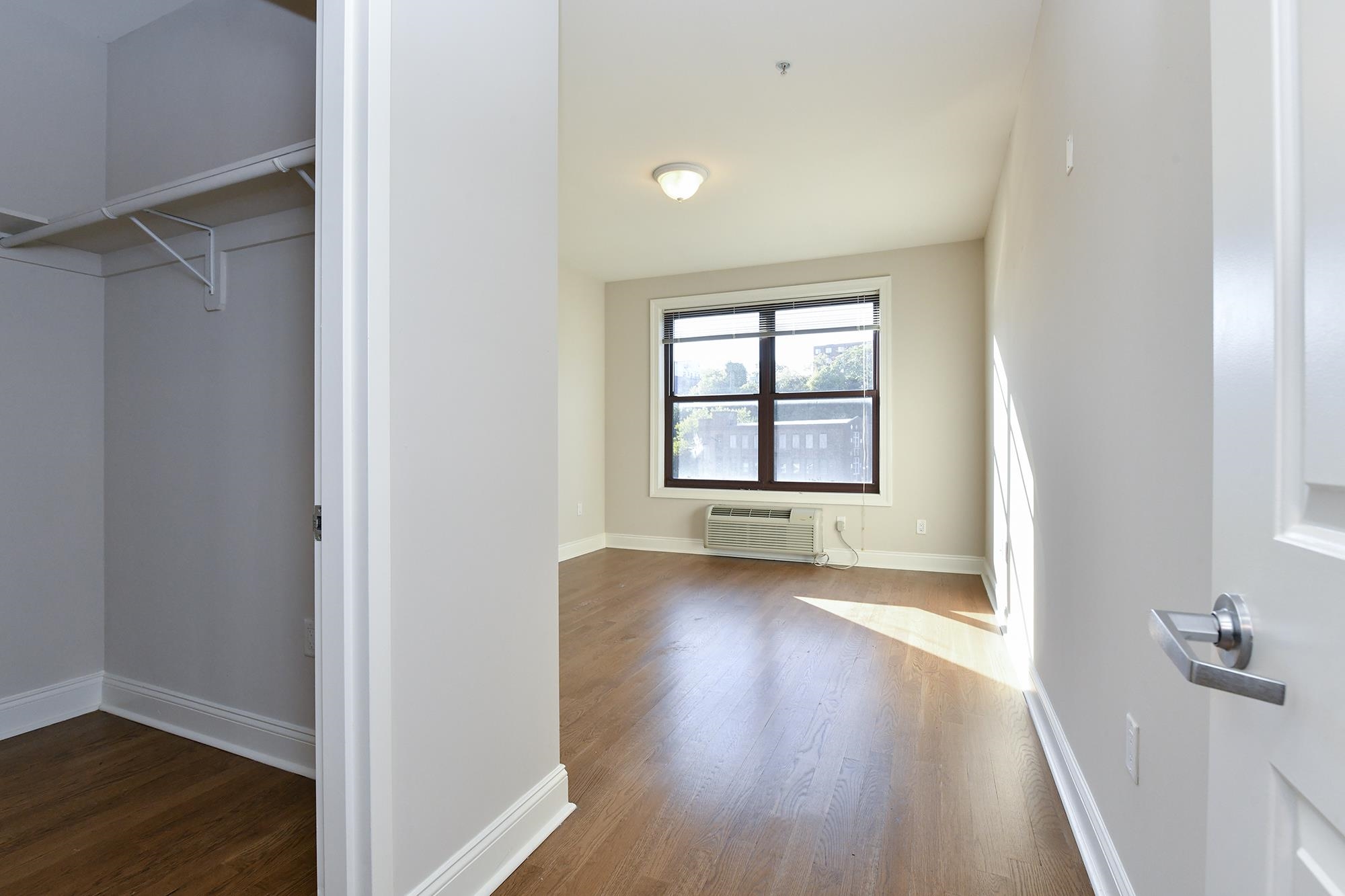 100 Marshall Street, Unit 608 Hoboken, NJ 07030 - Photo 11 of 22 an empty room with wooden floor and windows
