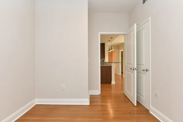 a view of a hallway with wooden floor