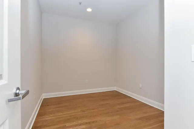 a view of a room with wooden floor