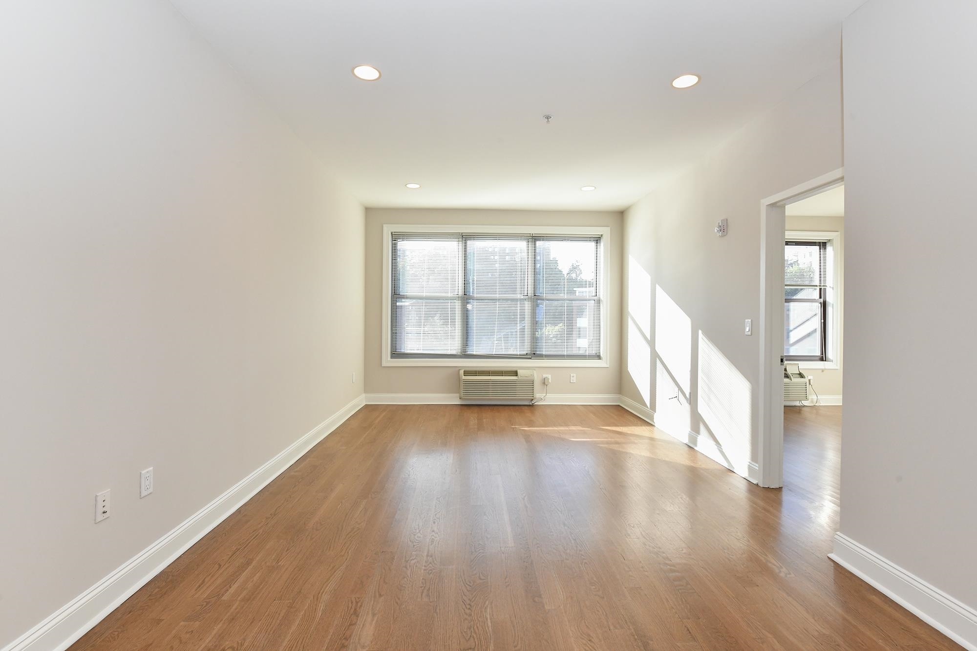 100 Marshall Street, Unit 608 Hoboken, NJ 07030 - Photo 2 of 22 wooden floor in an empty room with a window