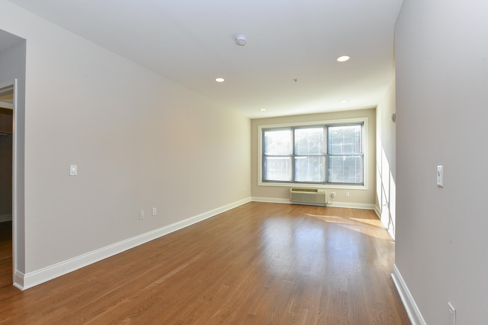100 Marshall Street, Unit 608 Hoboken, NJ 07030 - Photo 3 of 22 wooden floor in an empty room with a window