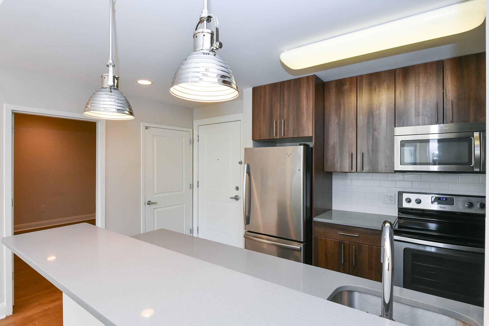 100 Marshall Street, Unit 608 Hoboken, NJ 07030 - Photo 4 of 22 a kitchen with stainless steel appliances a refrigerator and a stove top oven