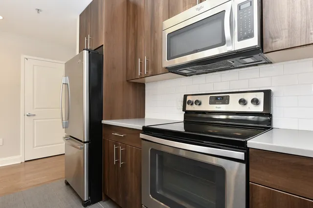 a kitchen with appliances and cabinets