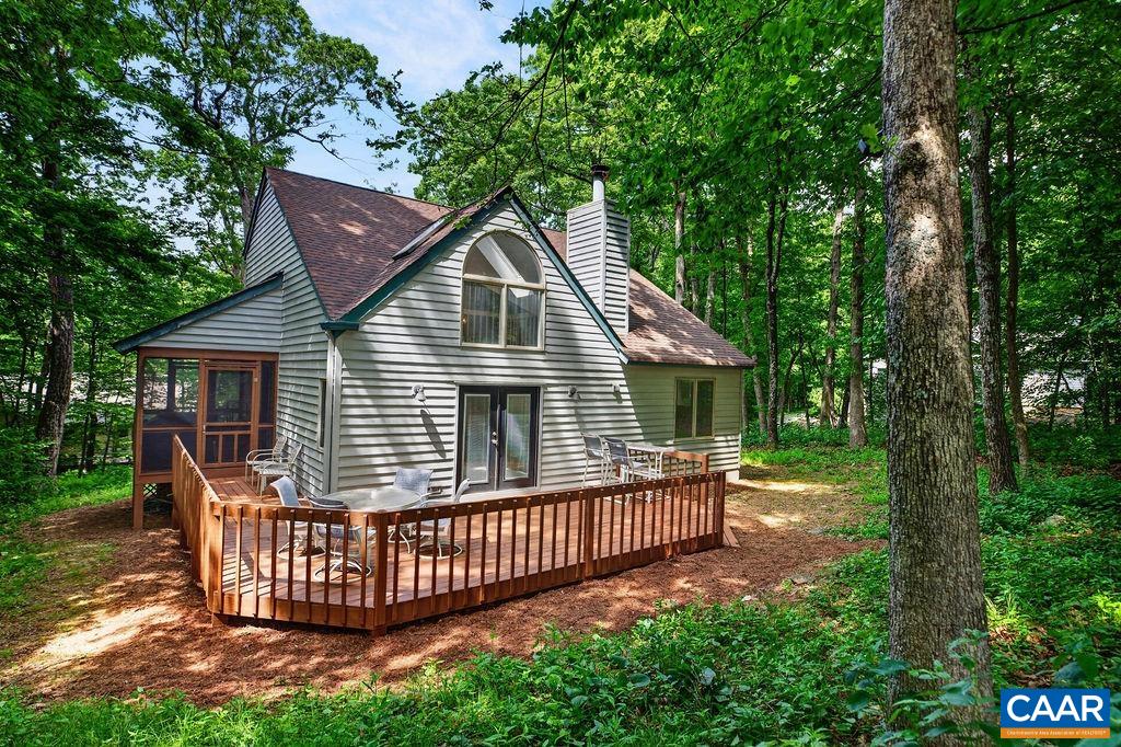 20 Blue Ridge Court Roseland, VA 22967 - Photo 4 of 56 The home features a screened porch and a generously sized rear deck, perfect for relaxing and enjoying the mountain setting and the golf fairway views.