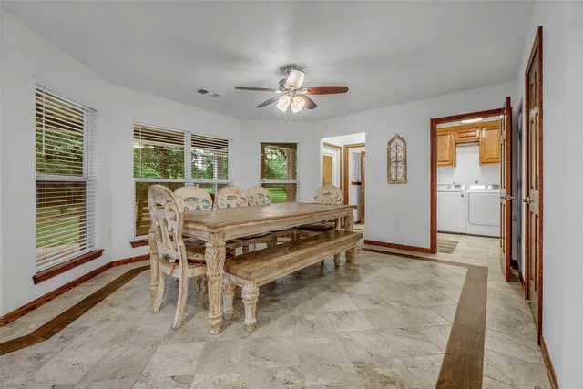 a dining room with furniture and window