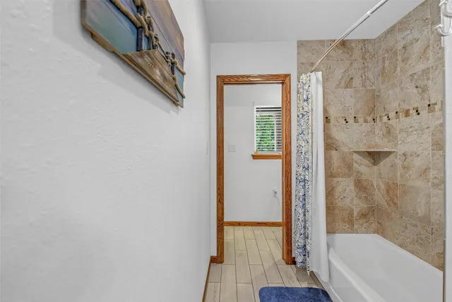 a bathroom with a bathtub and a shower