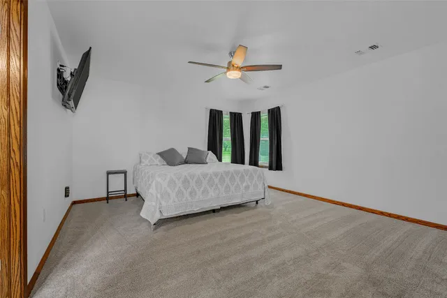 a living room with furniture and a ceiling fan