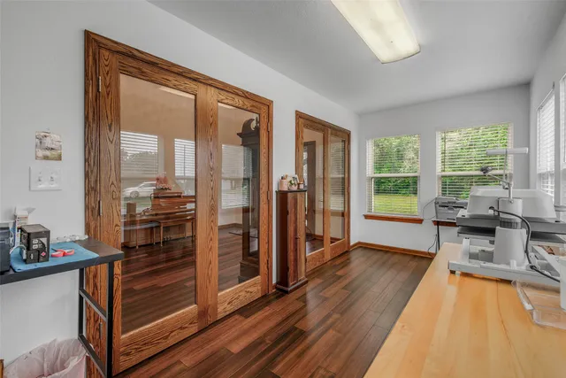 a view of a livingroom with furniture hardwood floor and a window