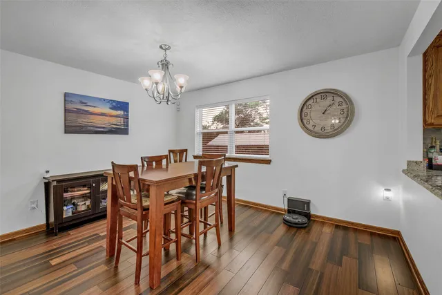 a view of a dining room with furniture wooden floor and a chandelier