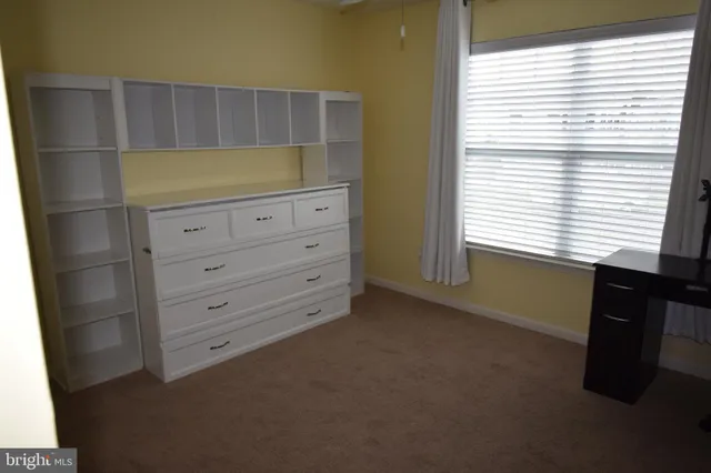 a kitchen with a window and cabinets
