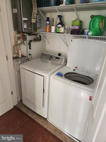 a utility room with sink dryer and washer