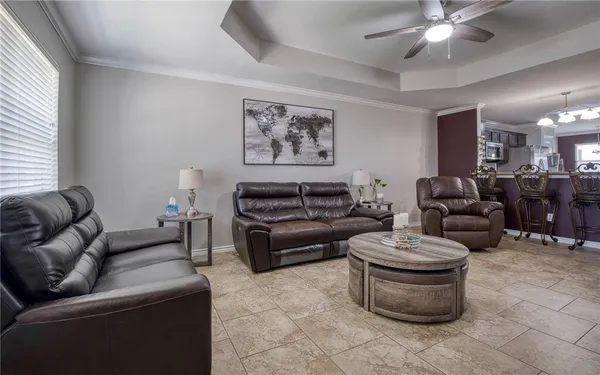 a living room with furniture and a chandelier