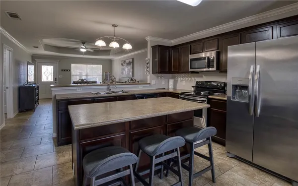 a kitchen with a table chairs refrigerator and microwave