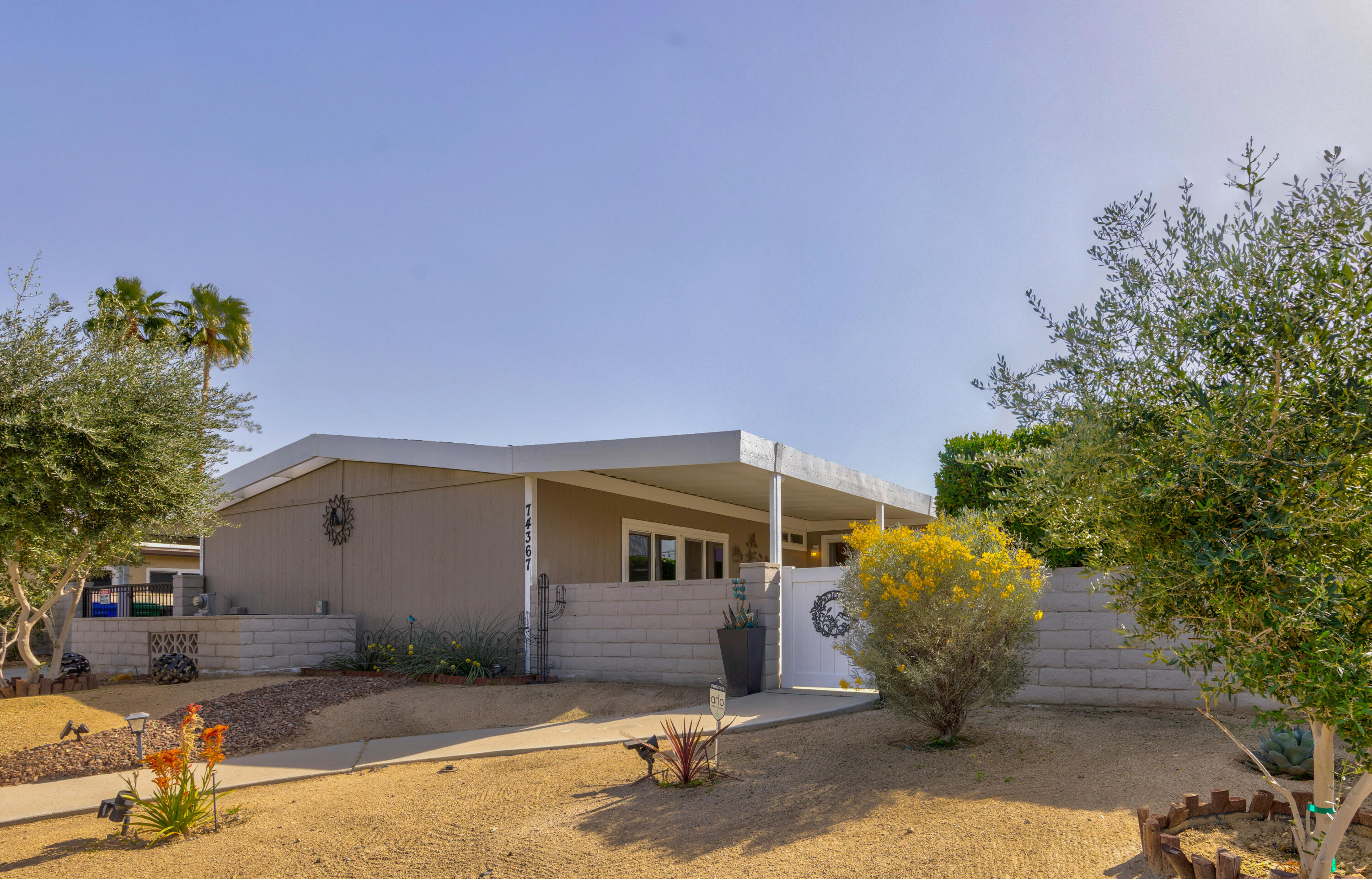 Undisclosed Address Palm Desert, CA 92260 - Photo 1 of 41 a front view of a house with garden