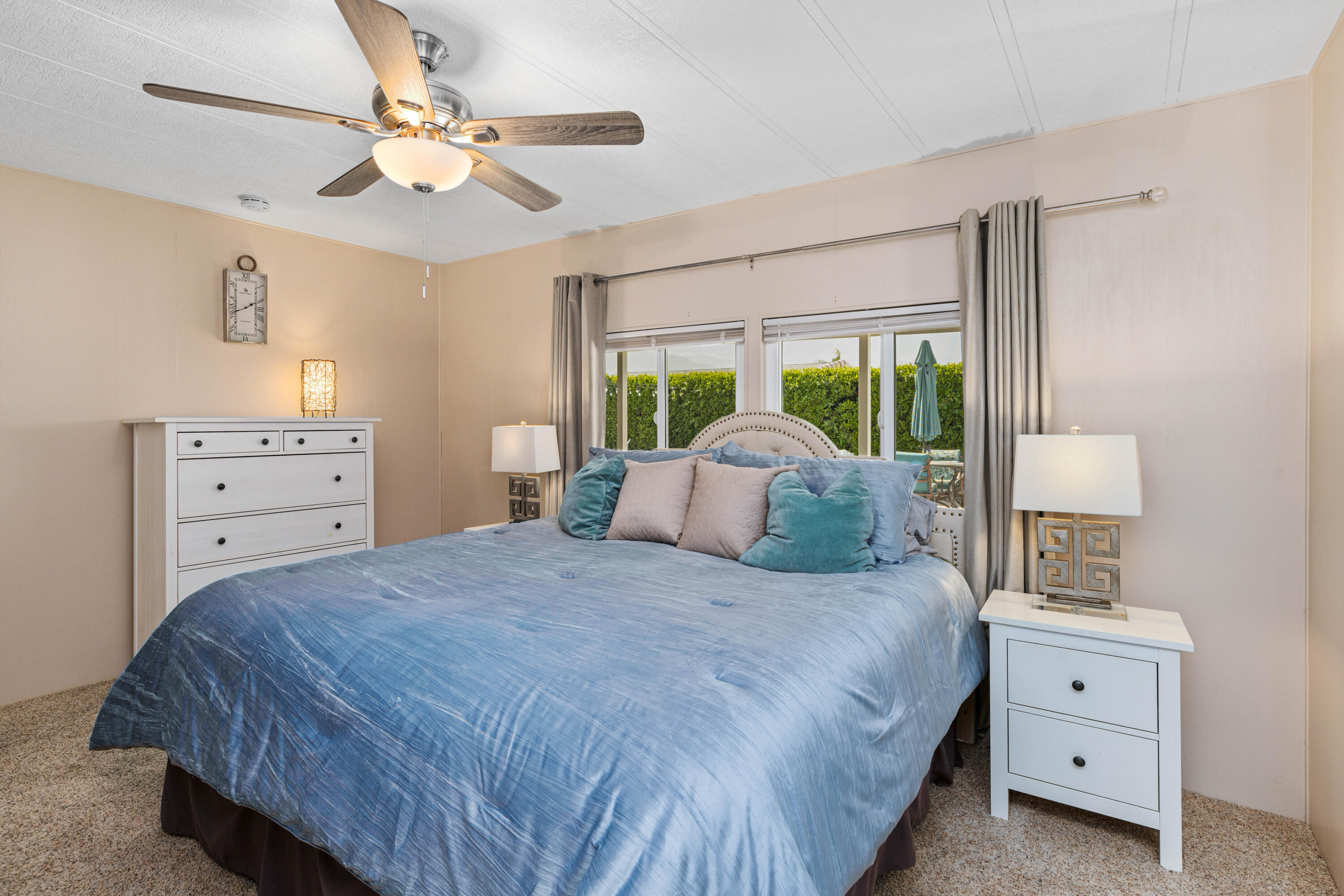 Undisclosed Address Palm Desert, CA 92260 - Photo 17 of 41 a bedroom with a large bed and a chandelier