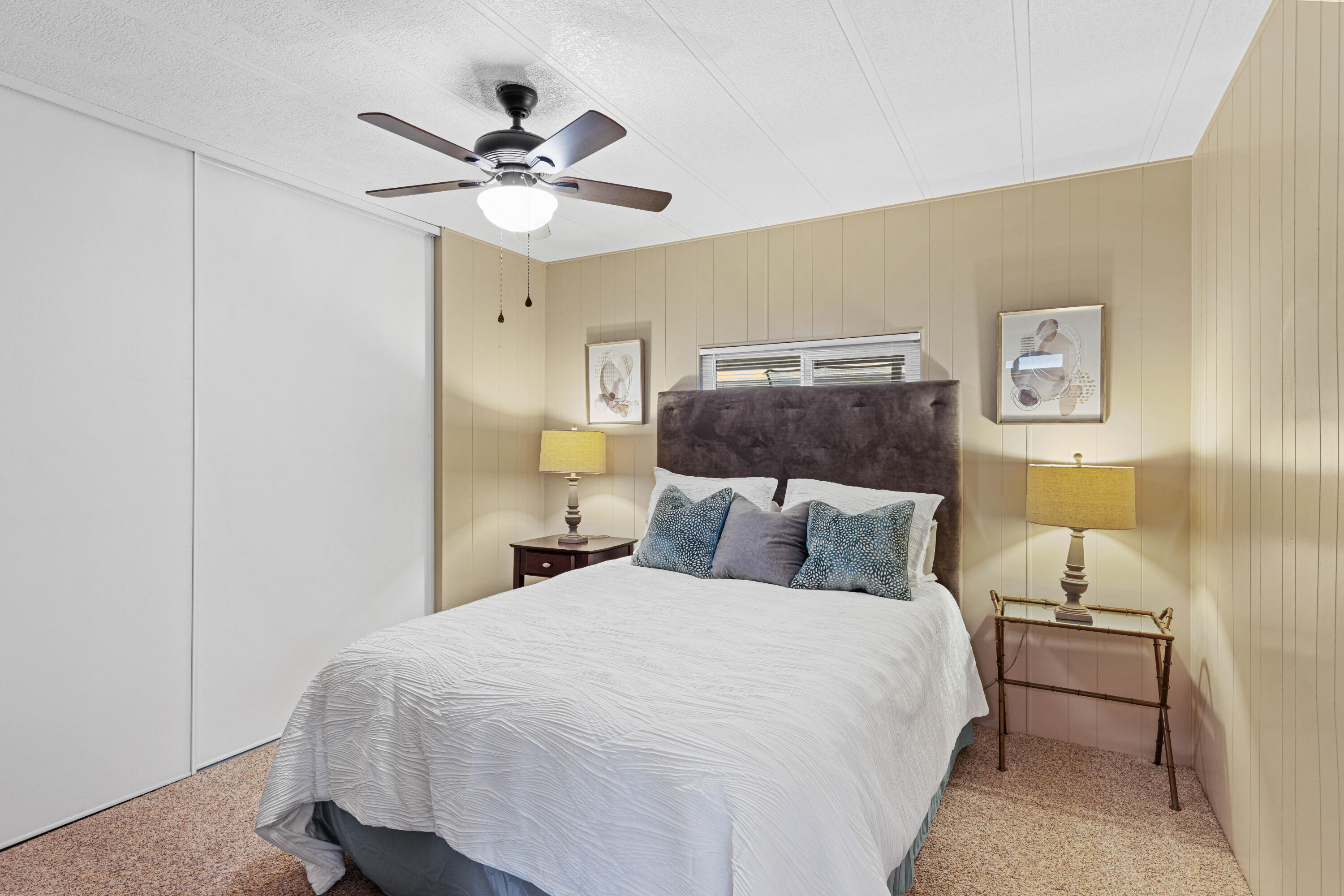 Undisclosed Address Palm Desert, CA 92260 - Photo 19 of 41 a bedroom with a bed and a chandelier