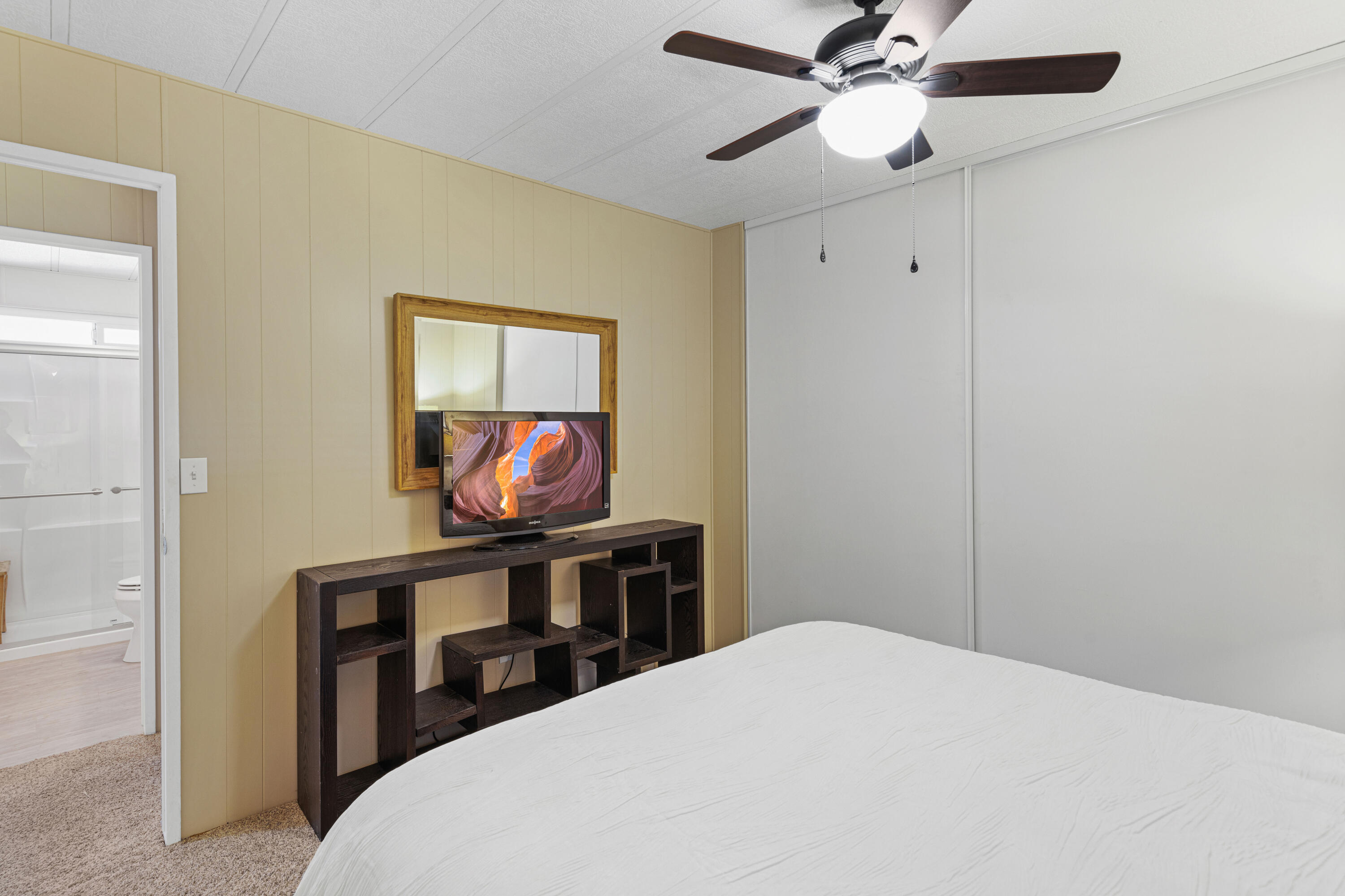 Undisclosed Address Palm Desert, CA 92260 - Photo 20 of 41 a bedroom with a bed and a chandelier